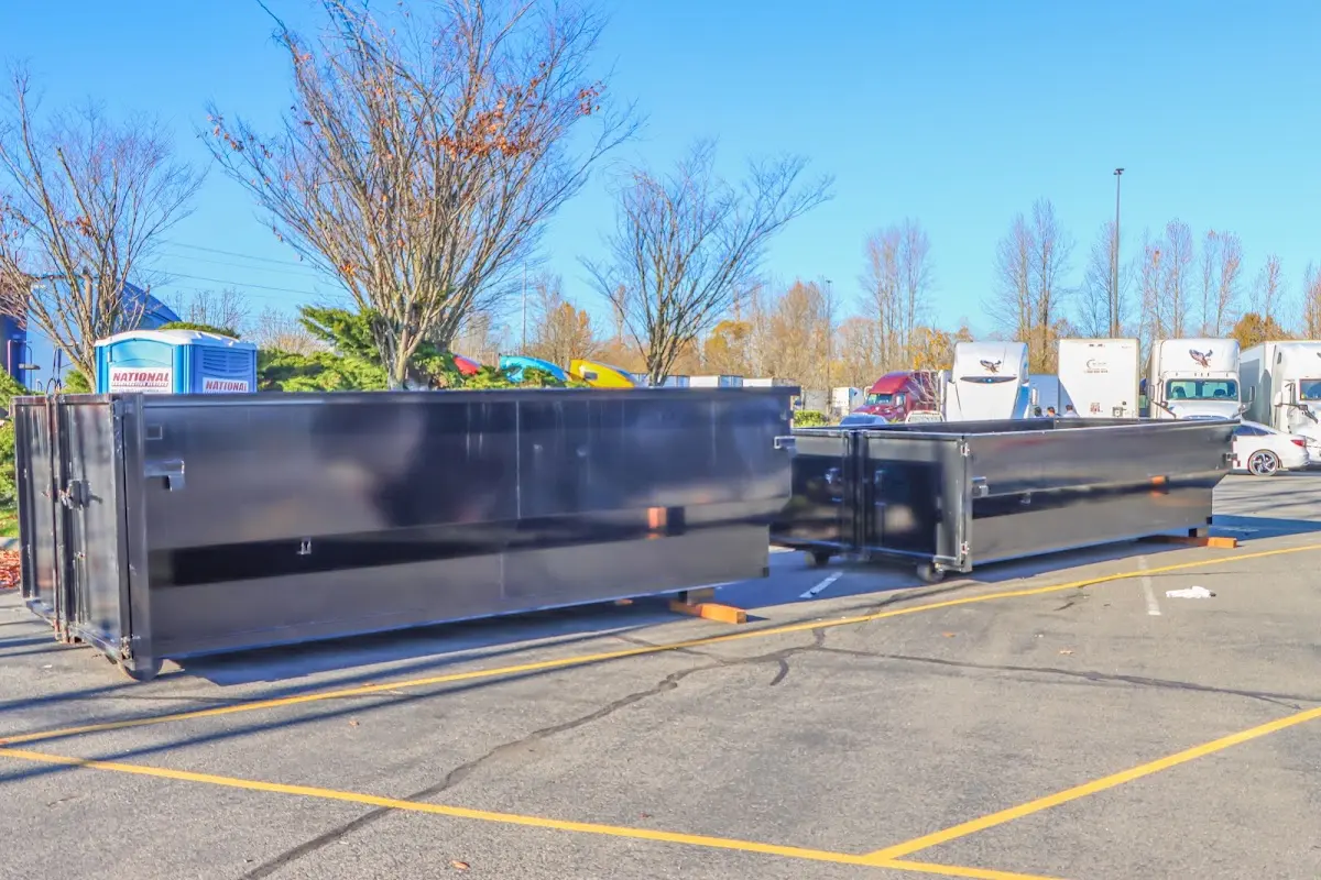 Professional dumpster rental service with roll-off container on residential driveway in Gaithersburg